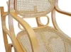 A close-up view of a wooden rocking chair with rattan seat and back. Voir les images du produit