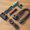 Various vacuum cleaner attachments laid out on a wooden floor. Náhled obrázku produktu