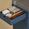 A close-up view of an open drawer in a blue shoe cabinet, revealing shoe care items. Produktbild-Vorschau