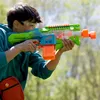 A young person is playing with a Nerf gun outdoors. Produktbild-Vorschau