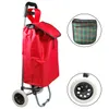 A red shopping trolley with a plaid pouch and a close-up of a wheel. Produktbild-Vorschau