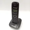 A black Panasonic cordless phone is shown sitting on its charging base against a white background. Podgląd zdjęcia produktu