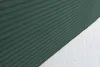 A close-up view of a green corduroy fabric and a white mattress. Produktbild-Vorschau