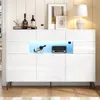 A white high-gloss sideboard with LED lighting, displaying bottles of wine and a vintage radio. Voir les images du produit