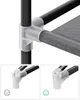 Close-up view of a gray fabric closet with black metal poles and clear plastic connectors, showing assembly details. Náhled obrázku produktu