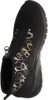 A black shoe with a circular pattern and a zipper. Produktbild-Vorschau