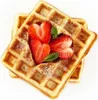 Two waffles topped with strawberries and mint leaves, dusted with powdered sugar. Produktbild-Vorschau