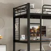 A close-up view of a black metal bunk bed with a desk and shelves underneath, set against a neutral background. Podgląd zdjęcia produktu