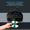 A hand holds a CD in front of a black CD player with a digital display and antenna. Produktbild-Vorschau