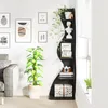 A modern black corner shelf unit filled with decorative items and plants, next to a sofa and framed artwork on a white wall. Podgląd zdjęcia produktu
