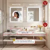 A bathroom vanity with two sinks and illuminated mirrors above. Anteprima dell’immagine prodotto