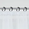 A close-up view of white sheer curtains hanging from a metal rod with black rings. Produktbild-Vorschau