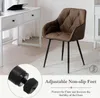 A brown accent chair with black metal legs is shown in a room with a white desk and a rug. Produktbild-Vorschau