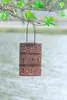 A decorative lantern hanging from a tree branch over a body of water. Produktbild-Vorschau