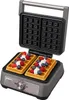 An open waffle maker with two waffles topped with whipped cream and berries. Náhľad obrázku produktu