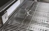 A close-up view of a stainless steel grill grate with a rotisserie spit. Produktbild-Vorschau