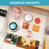 A collection of makeup products organized in a drawer. Produktbild-Vorschau