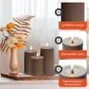 A vase with flowers and decorative leaves next to three LED candles on a wooden shelf. Anteprima dell’immagine prodotto
