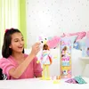 A young girl is playing with a Barbie Cutie Reveal doll in a bedroom setting. Náhľad obrázku produktu