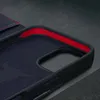 Close-up view of the interior of a dark blue leather iPhone case with a red lining. Produktbild-Vorschau