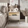 A bedroom scene featuring a nightstand next to a bed. Produktbild-Vorschau