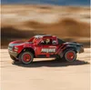 A remote-controlled truck driving on a sandy terrain. Produktbild-Vorschau