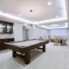 A modern basement game room with a pool table and seating area. Anteprima dell’immagine prodotto
