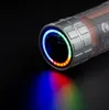 A close-up of the end of a cylindrical device with a ring of colorful LED lights and a beam of colored light projecting from it. Produktbild-Vorschau