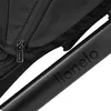 A close-up view of a black stroller frame with the brand name 'Lionelo' embossed on it, and a zipper pull with the brand name visible. Produktbild-Vorschau