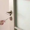 A hand is using a tool to open a door lock. Produktbild-Vorschau