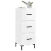 A white three-drawer cabinet with black handles and legs, topped with a vase of flowers and some books. Náhľad obrázku produktu