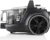 Side view of a black and transparent bagless vacuum cleaner with a large gray and black wheel. Produktbild-Vorschau