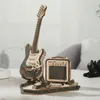 A wooden model of an electric guitar and amplifier on a white surface. Voir les images du produit