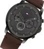 A close-up studio shot of a Tommy Hilfiger watch with a dark gray dial and a brown leather strap. Anteprima dell’immagine prodotto