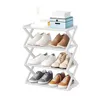 A white shoe rack filled with various shoes and two decorative boxes on top. Anteprima dell’immagine prodotto