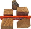 Several pieces of wood with grain patterns are arranged around a ruler. Produktbild-Vorschau