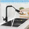 A black kitchen faucet with a pull-out spray is shown in use over a black sink. A hand is holding the spray head, and water is flowing into the sink. Text overlays describe the product's features. Produktbild-Vorschau