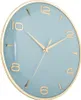 A close-up, angled view of a wall clock with a light blue face and gold numbers and hands. Produktbild-Vorschau