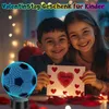 Two children are smiling and holding a Valentine's Day card, with a soccer ball lamp in the foreground. Produktbild-Vorschau