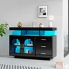 A black sideboard with glass doors and drawers, illuminated by blue LED lights. Náhled obrázku produktu