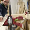 A person is using a clamp in a workshop setting. Náhled obrázku produktu