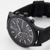 A close-up shot of a black Emporio Armani watch. Voir les images du produit