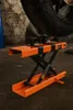 A motorcycle lift is shown in a garage setting. Náhled obrázku produktu