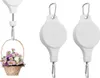 A hanging basket with flowers is shown on the left, and two white retractable plant hangers are shown on the right. Náhled obrázku produktu