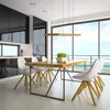 A modern dining room with a table and chairs set against a large window overlooking the ocean. Náhled obrázku produktu