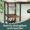 A close-up view of a bar table with wine glasses hanging and wine bottles stored below, with text overlay. Produktbild-Vorschau