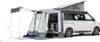 A white camper van with a pop-top roof and an attached awning/tent structure, shown from the side and slightly angled. Produktbild-Vorschau