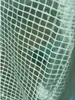 A close-up view of a greenhouse made of plastic sheeting with a grid pattern. Produktbild-Vorschau