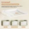 A white changing table attachment with a removable divider, shown on a plain background and in three different configurations on top of a dresser. Náhľad obrázku produktu