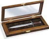 A decorative letter opener shaped like a sword, displayed in a wooden case with a mirrored lid. Anteprima dell’immagine prodotto